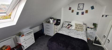 Bright and cozy bedroom with a comfortable doub...
