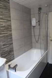 Modern bathroom featuring a large bathtub, a sh...