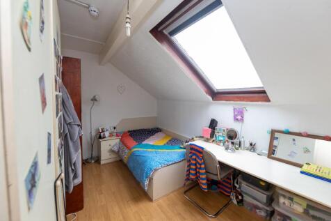 Bright and cozy bedroom with personal touches, ...