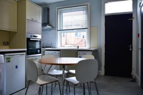 A compact, bright kitchen featuring a round woo...