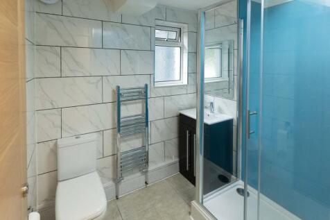 Modern bathroom featuring large marble tiles, a...