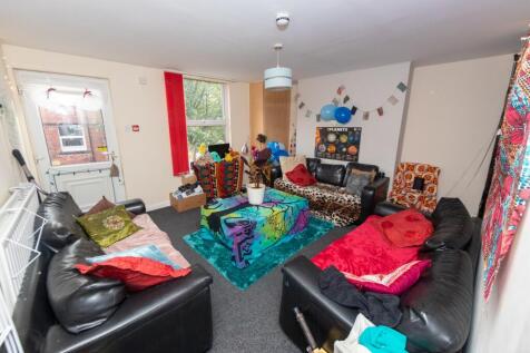 A cozy and vibrant living room filled with colo...