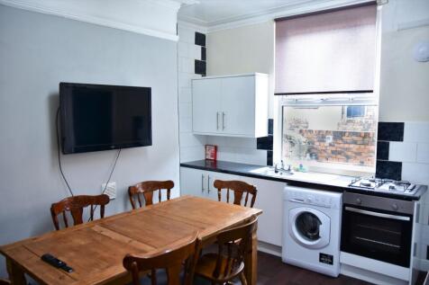 A bright, functional kitchen featuring a washin...