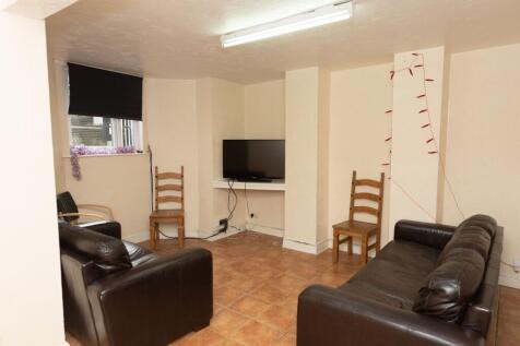 A cozy living room featuring two leather sofas,...