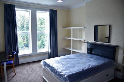 A bright and well-maintained bedroom featuring ...