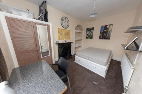 Cozy bedroom featuring a single bed, a wardrobe...