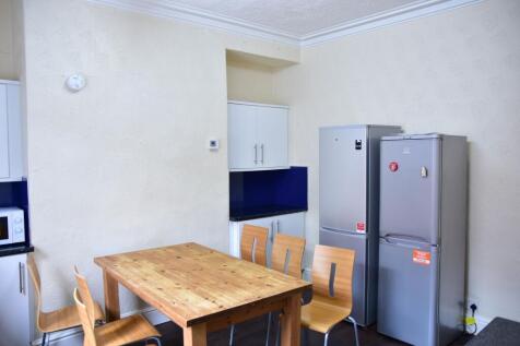 A well-maintained kitchen with a wooden dining ...