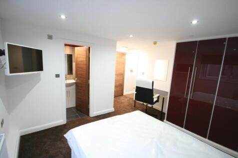 A bright and modern bedroom featuring a large w...