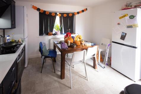 A functional kitchen area with a wooden dining ...