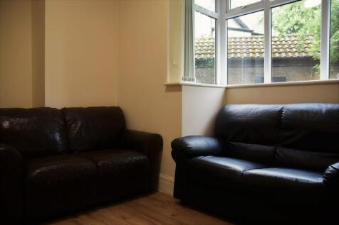 A cozy living room featuring two black leather ...