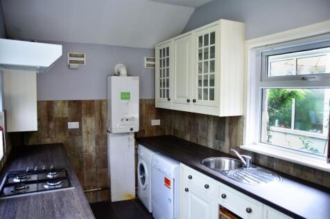 Bright and functional kitchen with white cabine...