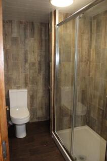 A modern bathroom featuring a shower enclosure ...