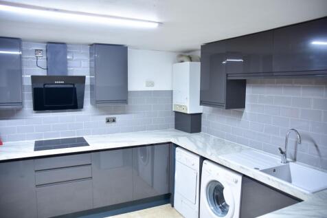 Modern and clean kitchen with sleek grey cabine...