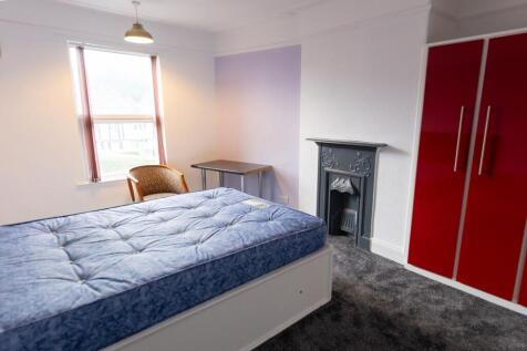 A bright and inviting double bedroom featuring ...