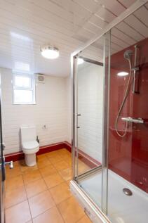 Bright and clean bathroom with white tiled wall...