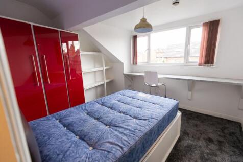 A bright and airy double bedroom featuring a la...