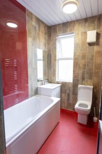 Modern bathroom featuring a large bathtub with ...