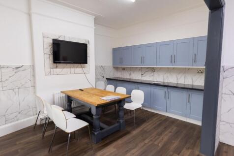 Bright and clean kitchen with light blue cabine...
