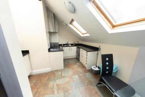Bright and functional kitchen area featuring sk...