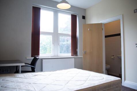 Bright and airy bedroom featuring a large windo...