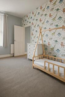 A bright and welcoming bedroom featuring a whim...
