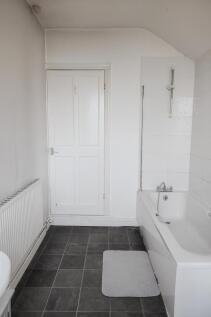 A clean and functional bathroom featuring a whi...