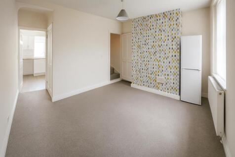 Bright and airy living room featuring a clean, ...