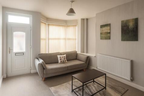 A bright and modern living room featuring a com...