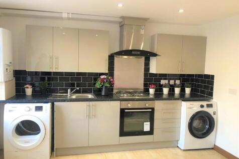 Bright and modern kitchen featuring sleek cabin...
