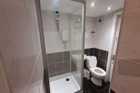 Modern bathroom featuring a spacious walk-in sh...