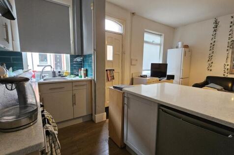A modern kitchen featuring ample countertop spa...