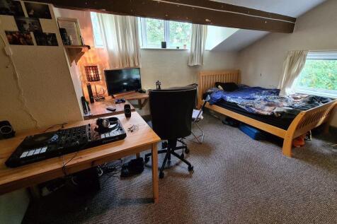 Bright and spacious master bedroom featuring a ...
