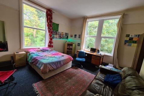 Bright and spacious bedroom featuring two large...