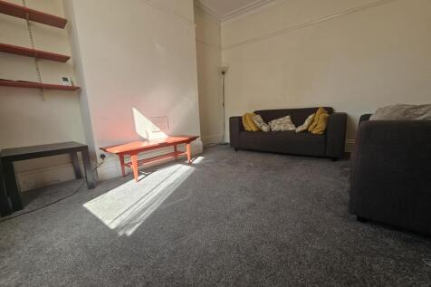 Bright and welcoming living room with natural s...