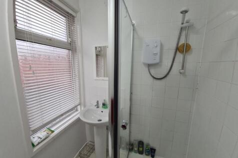 Bright and clean bathroom with a shower, ample ...