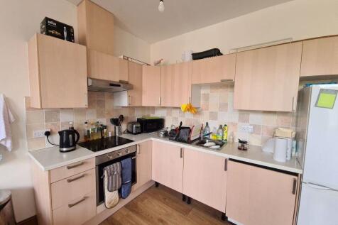 A modern, well-equipped kitchen featuring light...