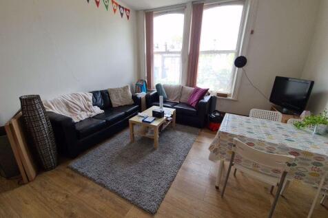A bright and welcoming living room featuring a ...