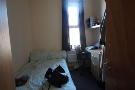 Cozy single bedroom featuring a comfortable bed...