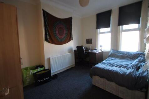 Cozy single bedroom featuring a comfortable bed...