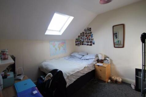 A cozy attic bedroom featuring a skylight that ...