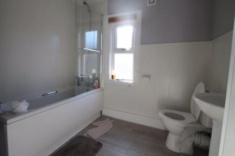 A bright and clean bathroom featuring a full ba...