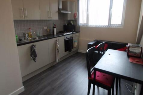 Bright and tidy kitchen featuring modern cabine...
