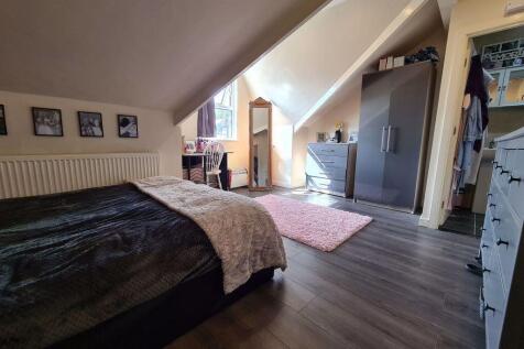 Spacious master bedroom featuring a comfortable...