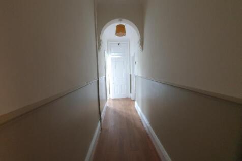 A clean and simple hallway with wooden flooring...