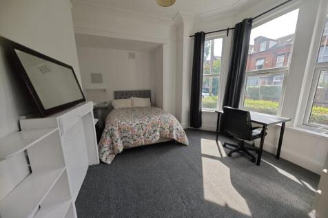 A bright and airy double bedroom featuring a co...
