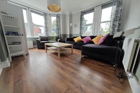 Bright and spacious living room featuring large...