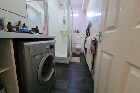 A clean, well-maintained bathroom with a shower...