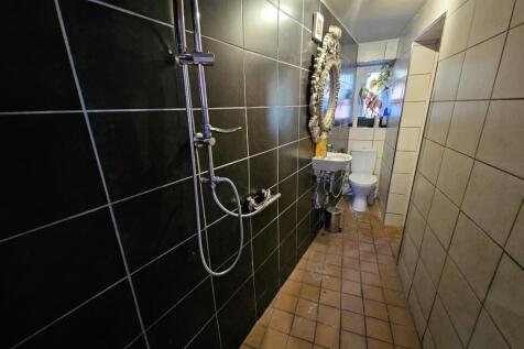 A modern bathroom with a large shower area, fea...