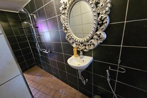 A clean, well-maintained bathroom featuring a d...