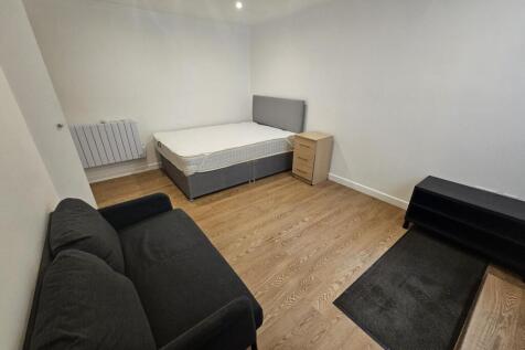 A modern, clean living room featuring a comfort...